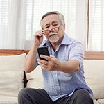 man struggling to see phone screen due to macular degeneration